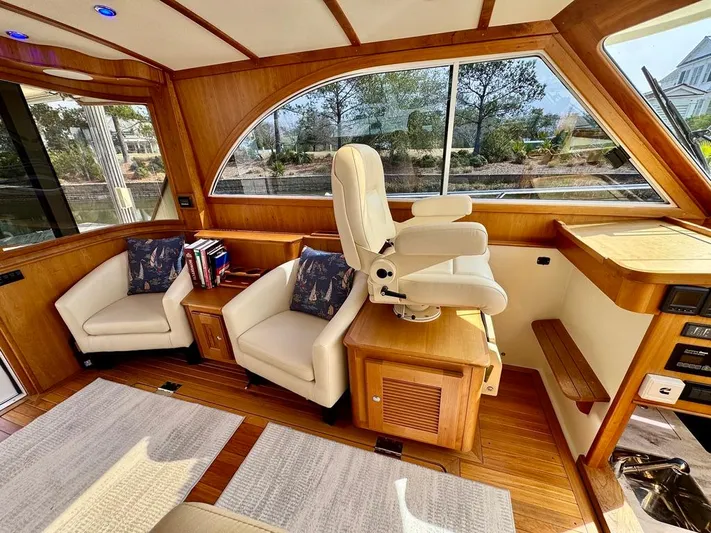 Linda Lou Yacht Photos Pics Luxurious interior of a 2018 Legacy 36 yacht with plush seating and elegant wood finishes.