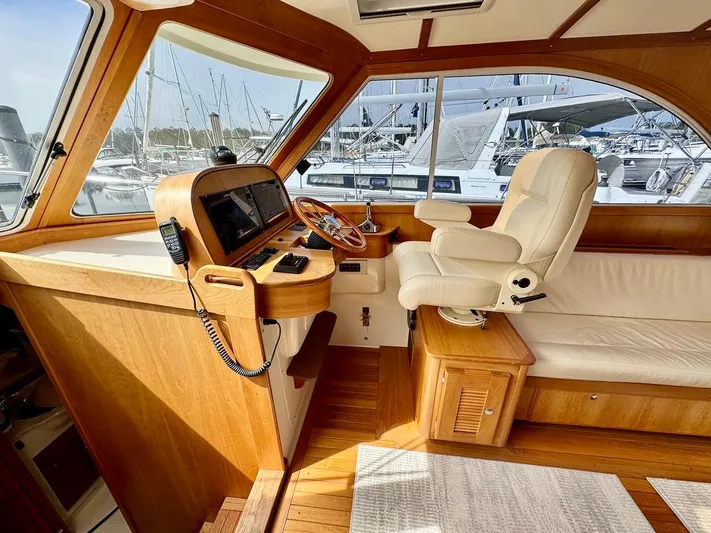 Linda Lou Yacht Photos Pics Luxurious interior of a 2018 Legacy 36 yacht with helm and seating area.