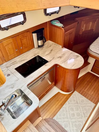Linda Lou Yacht Photos Pics 2018 Legacy 36 yacht kitchen with modern appliances and wooden cabinetry.