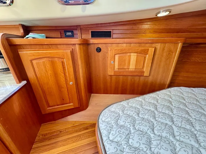 Linda Lou Yacht Photos Pics 2018 Legacy 36 yacht interior with wooden cabinetry and patterned mattress.