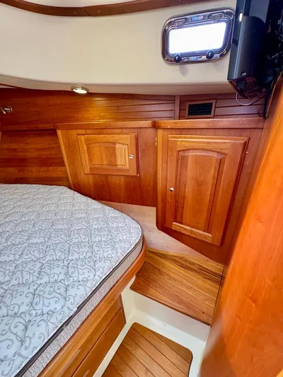 Linda Lou Yacht Photos Pics 2018 Legacy 36 yacht cabin with wooden interior and cozy bed.