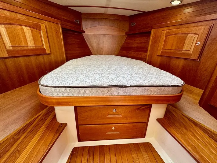 Linda Lou Yacht Photos Pics 2018 Legacy 36 boat interior with wooden cabinetry and a comfortable bed.