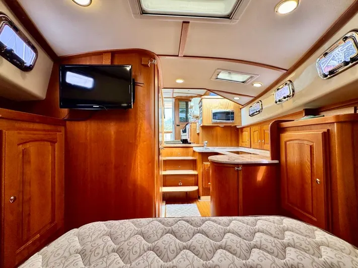 Linda Lou Yacht Photos Pics Luxurious interior of a 2018 Legacy 36 yacht with wood finish and modern amenities.