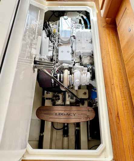 Linda Lou Yacht Photos Pics Engine compartment of a 2018 Legacy 36 boat, showcasing mechanical components and Legacy branding.