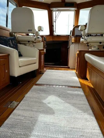 Linda Lou Yacht Photos Pics Interior of 2018 Legacy 36 boat with wooden flooring and white seating.