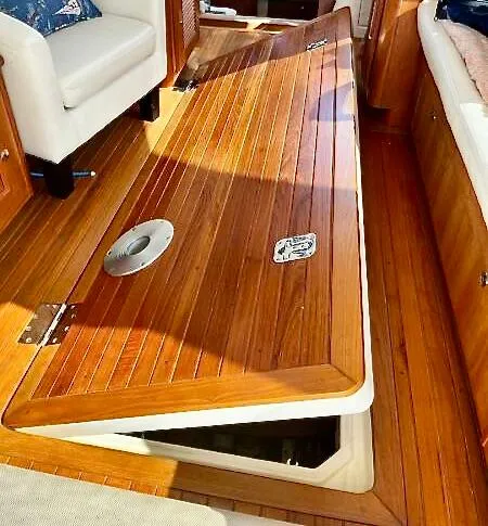 Linda Lou Yacht Photos Pics 2018 Legacy 36 yacht interior with wooden flooring and storage compartment.