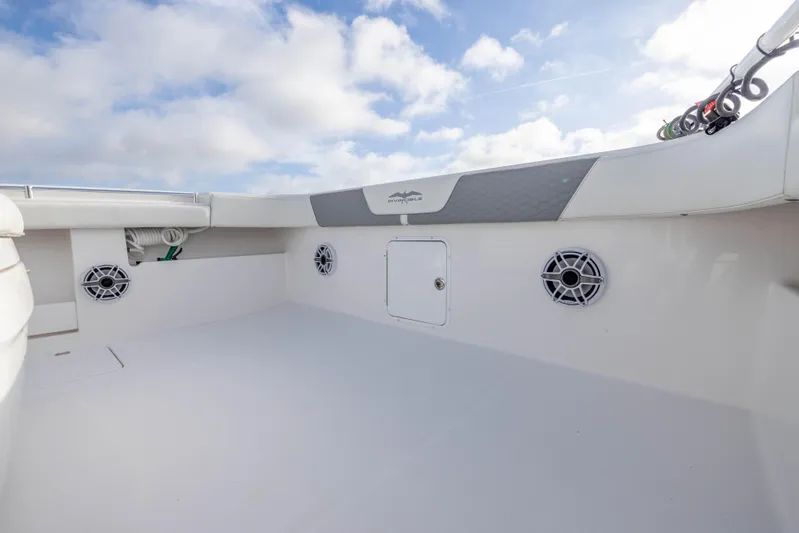 Nordic Blue Yacht Photos Pics 2024 Invincible 35 Catamaran deck with speakers and storage, under a cloudy sky.