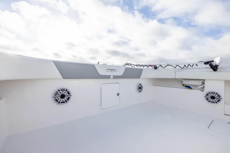 Nordic Blue Yacht Photos Pics 2024 Invincible 35 Catamaran deck with speakers and storage compartments under a cloudy sky.