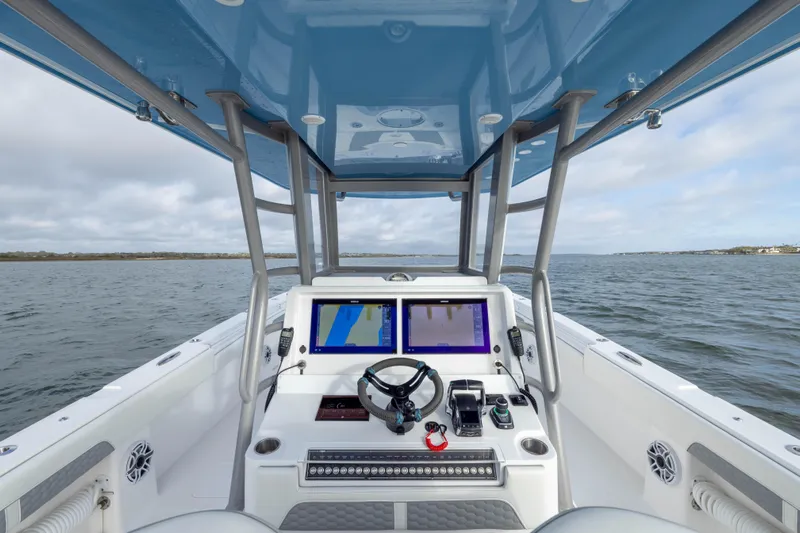 Nordic Blue Yacht Photos Pics 2024 Invincible 35 Catamaran helm with dual screens, steering wheel, and ocean view.