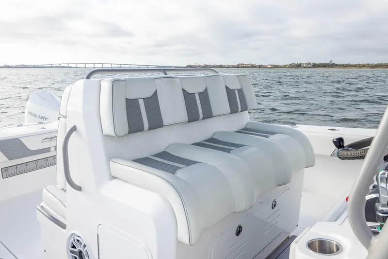 Nordic Blue Yacht Photos Pics 2024 Invincible 35 Catamaran with luxurious seating, on open water with bridge in background.