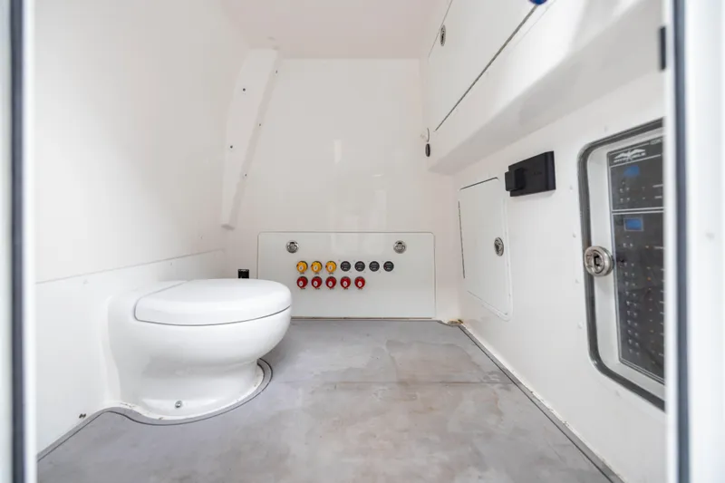 Nordic Blue Yacht Photos Pics 2024 Invincible 35 Catamaran interior with toilet and control panel.