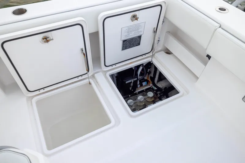 Nordic Blue Yacht Photos Pics 2024 Invincible 35 Catamaran deck with open storage compartments and visible wiring.