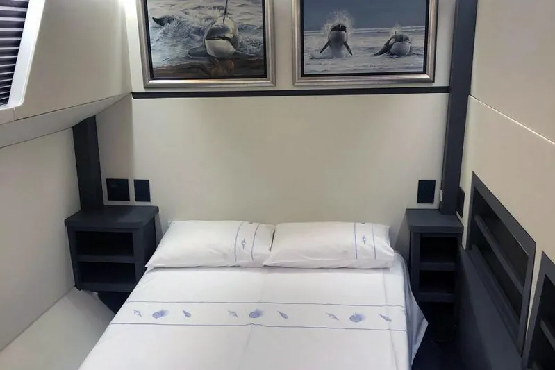 Pilar X Yacht Photos Pics Luxurious 2024 Leeuwin 55 yacht bedroom with marine-themed decor and elegant bedding.