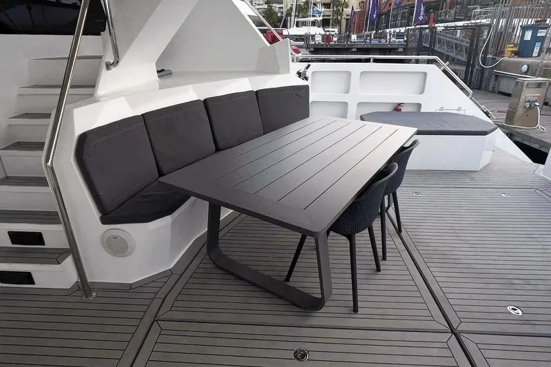 Pilar X Yacht Photos Pics Luxury seating area on 2024 Leeuwin 55 yacht with modern table and cushions.