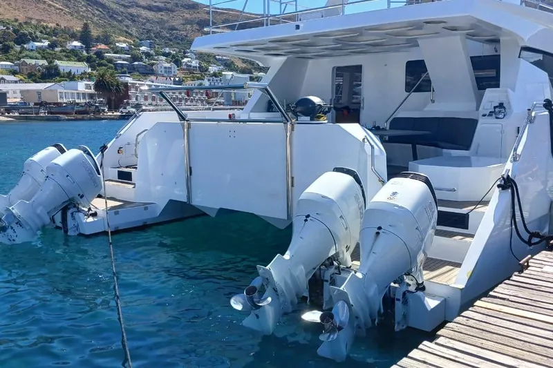 Pilar X Yacht Photos Pics 2024 Leeuwin 55 yacht docked, featuring dual outboard motors and spacious deck area.