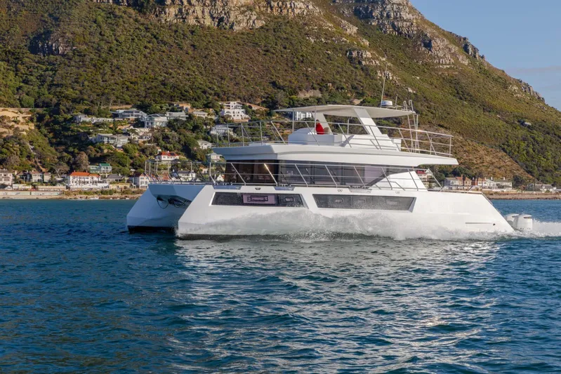 Pilar X Yacht Photos Pics 2024 Leeuwin 55 yacht cruising near scenic coastal landscape.