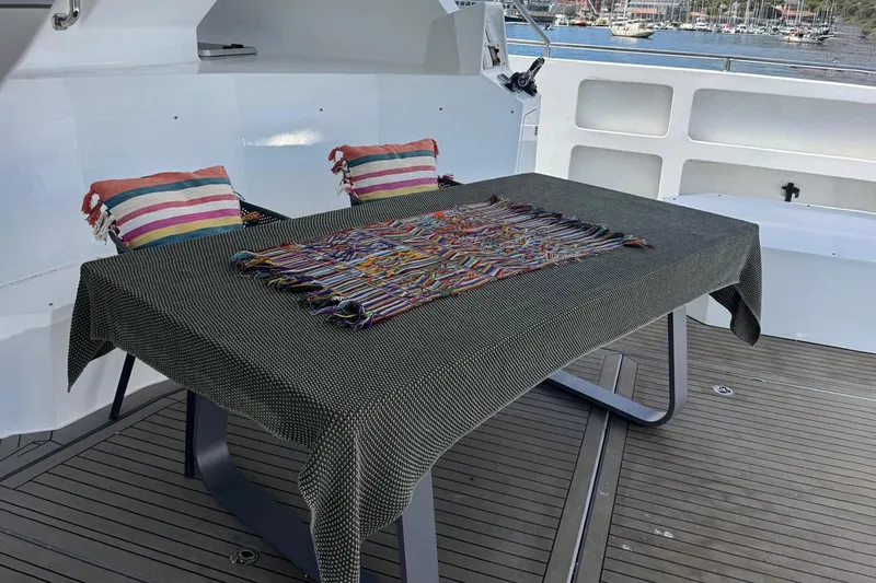 Pilar X Yacht Photos Pics Leeuwin 55 yacht deck with table and cushions, 2024 model.