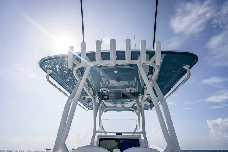 34 Offshore Yacht Photos Pics 2025 Yellowfin 34 Offshore boat, sunlit T-top, clear sky background.