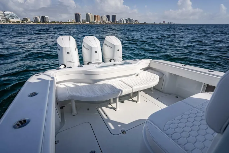 34 Offshore Yacht Photos Pics 2025 Yellowfin 34 Offshore boat with triple Mercury engines on open water.