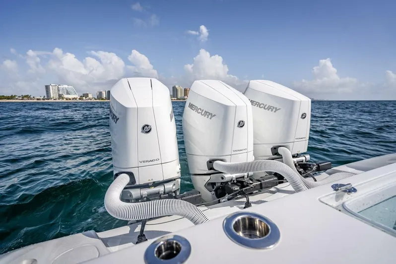 34 Offshore Yacht Photos Pics 2025 Yellowfin 34 Offshore boat with triple Mercury Verado engines on open sea.