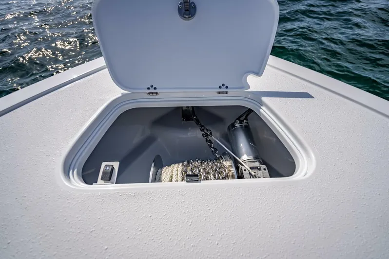 34 Offshore Yacht Photos Pics Open anchor locker on 2025 Yellowfin 34 Offshore boat, showing chain and winch mechanism.