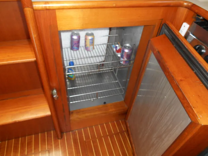 Balmy Yacht Photos Pics Wooden interior of 1999 Grand Banks 38 Eastbay EX with open mini fridge.