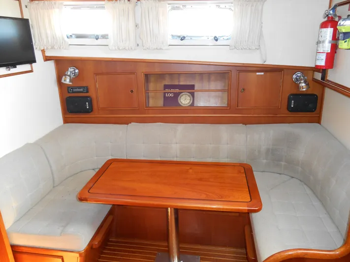 Balmy Yacht Photos Pics Interior of 1999 Grand Banks 38 Eastbay EX with cozy seating and wooden table.
