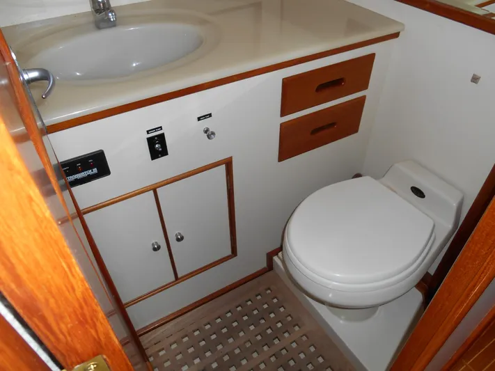 Balmy Yacht Photos Pics Bathroom interior of 1999 Grand Banks 38 Eastbay EX yacht, featuring sink and toilet.