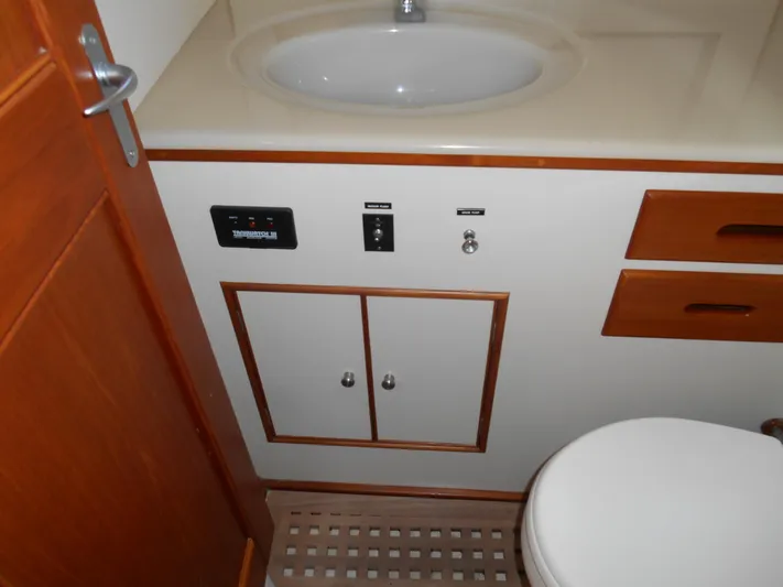 Balmy Yacht Photos Pics Bathroom interior of 1999 Grand Banks 38 Eastbay EX yacht, featuring sink and storage.