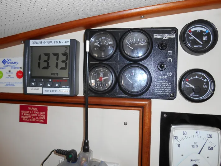 Balmy Yacht Photos Pics Control panel of a 1999 Grand Banks 38 Eastbay EX boat, displaying various gauges and voltmeter.