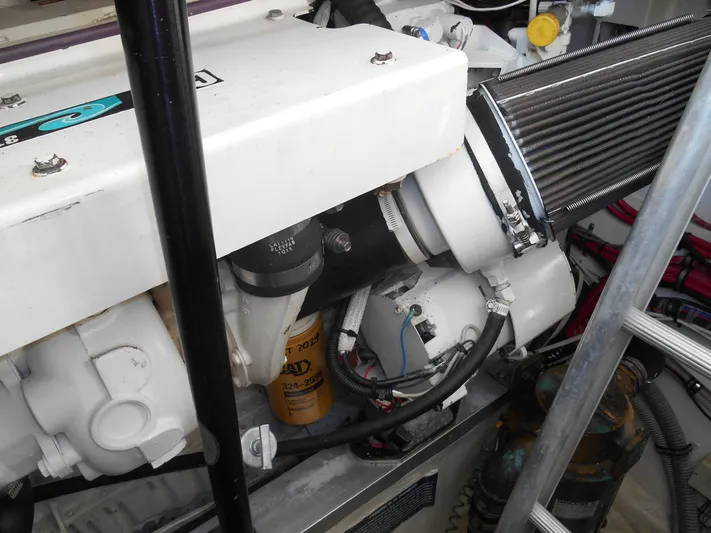 Balmy Yacht Photos Pics Engine compartment of 1999 Grand Banks 38 Eastbay EX, showcasing mechanical components and filters.