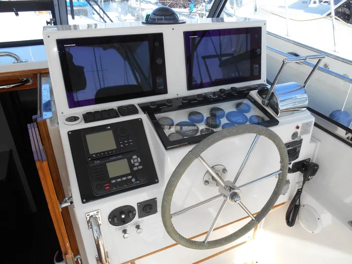 Balmy Yacht Photos Pics Helm of 1999 Grand Banks 38 Eastbay EX with dual screens and navigation controls.