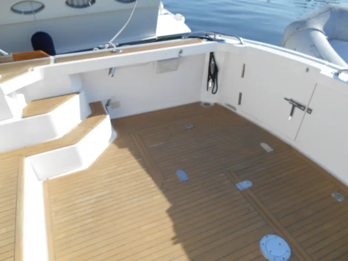 Balmy Yacht Photos Pics 1999 Grand Banks 38 Eastbay EX boat deck with wooden flooring and white steps.