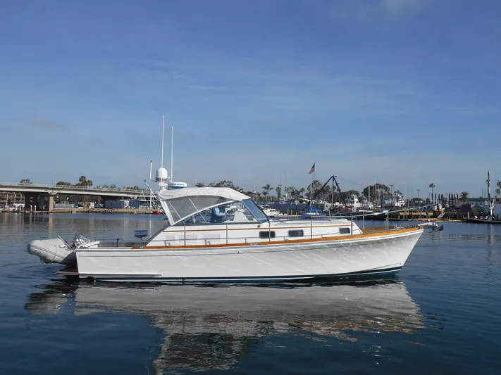 Balmy Yacht Photos Pics 1999 Grand Banks 38 Eastbay EX yacht on calm water, clear sky background.