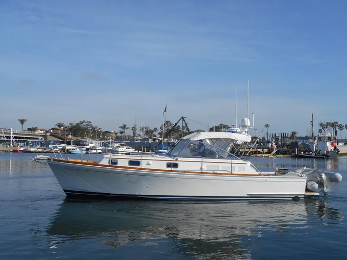 Balmy Yacht Photos Pics 1999 Grand Banks 38 Eastbay EX yacht docked in a marina under clear skies.