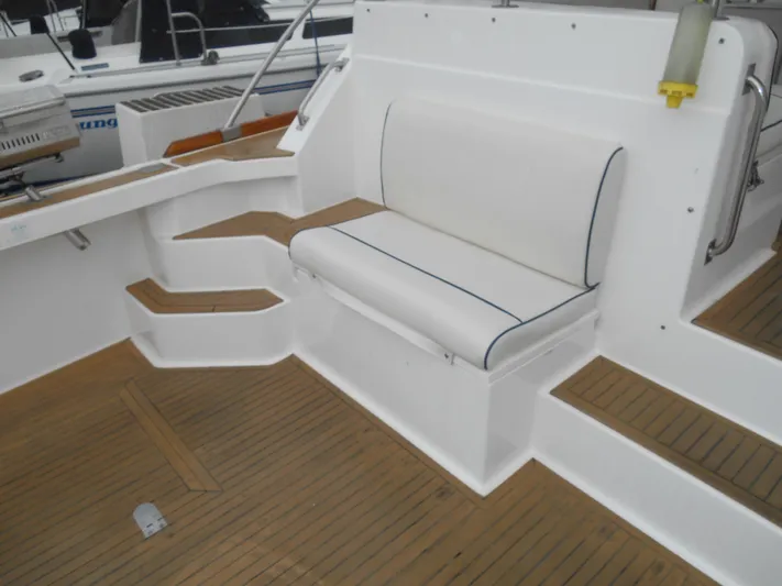 Balmy Yacht Photos Pics 1999 Grand Banks 38 Eastbay EX boat interior with white seating and teak flooring.
