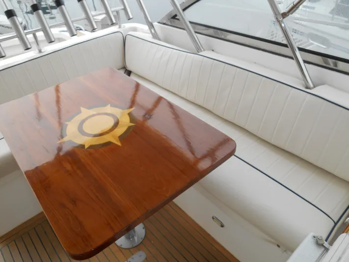 Balmy Yacht Photos Pics Luxurious seating area on 1999 Grand Banks 38 Eastbay EX yacht with polished wooden table.