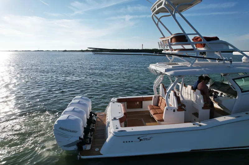 Yacht Photos Pics 2019 Scout 420 LXF boat on calm water, featuring dual Mercury engines.