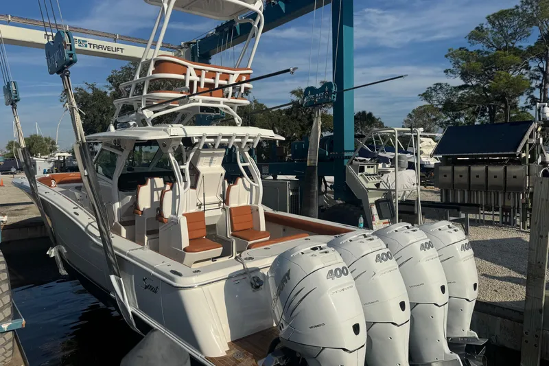  Yacht Photos Pics 2019 Scout 420 LXF boat with quad 400 engines in a marina setting.
