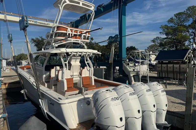  Yacht Photos Pics 2019 Scout 420 LXF boat with four powerful outboard engines at a marina.