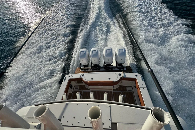  Yacht Photos Pics 2019 Scout 420 LXF boat with four engines cruising on water, leaving a wake.