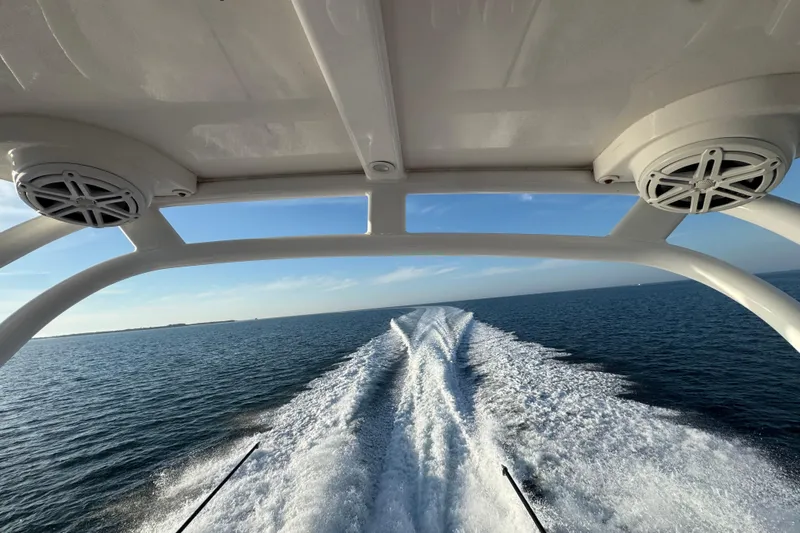  Yacht Photos Pics 2019 Scout 420 LXF boat cruising on open water, leaving a wake trail.