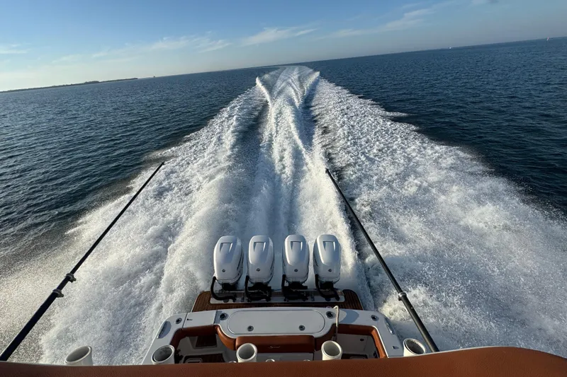  Yacht Photos Pics 2019 Scout 420 LXF boat cruising on open water, leaving a wake behind.