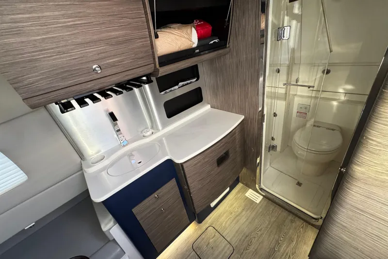  Yacht Photos Pics Luxurious 2019 Scout 420 LXF boat interior with modern bathroom and sleek cabinetry.