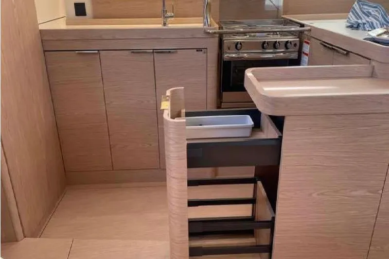 One Five Yacht Photos Pics Modern kitchen interior of 2022 Beneteau Oceanis Yacht 54 with sleek cabinetry and appliances.