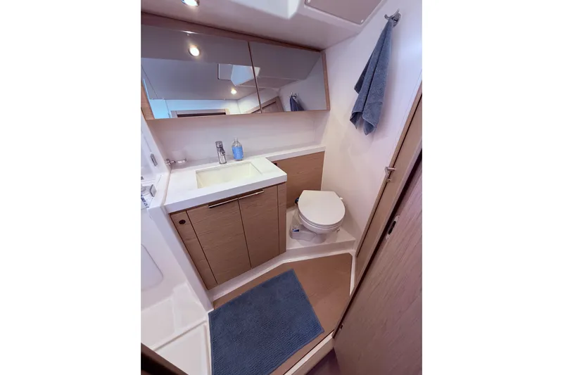 One Five Yacht Photos Pics Modern bathroom in 2022 Beneteau Oceanis Yacht 54, featuring sleek design and amenities.