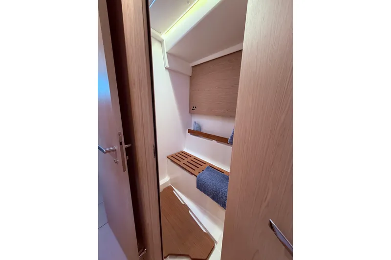 One Five Yacht Photos Pics Interior of 2022 Beneteau Oceanis Yacht 54, featuring a sleek wooden bathroom design.
