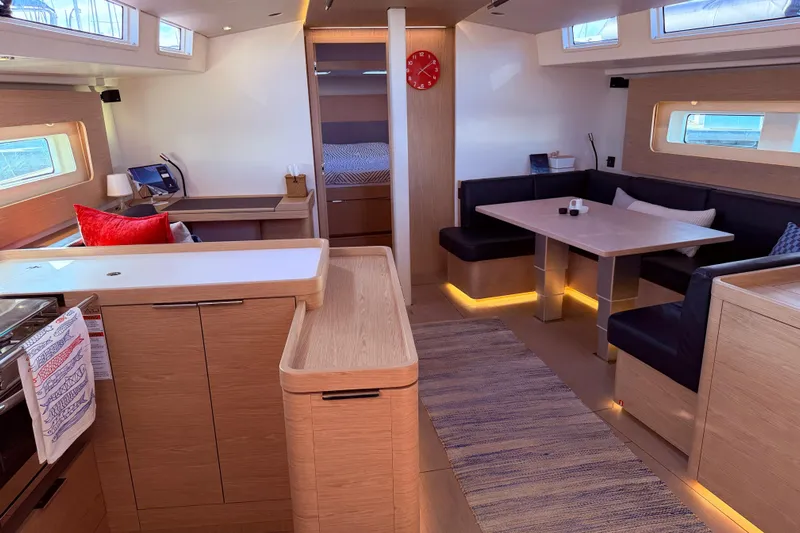 One Five Yacht Photos Pics Luxurious interior of 2022 Beneteau Oceanis Yacht 54 with modern dining and seating area.