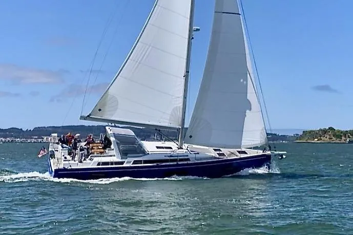 One Five Yacht Photos Pics 2022 Beneteau Oceanis Yacht 54 sailing on open water under clear skies.