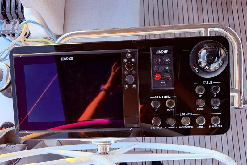 One Five Yacht Photos Pics Control panel of 2022 Beneteau Oceanis Yacht 54 with navigation display and compass.